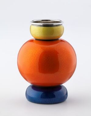  "Appelsinen," a decorative object by Jacob Tostrup Prytz, featuring a punch-gilt sterling silver form covered in mirror enamel with a blue base, vibrant orange body, and a yellow band leading to a silver top, set against a plain background.