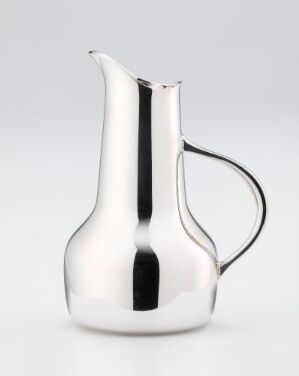  A modern, reflective metallic pitcher with a smooth design and elongated spout on a plain grey background.