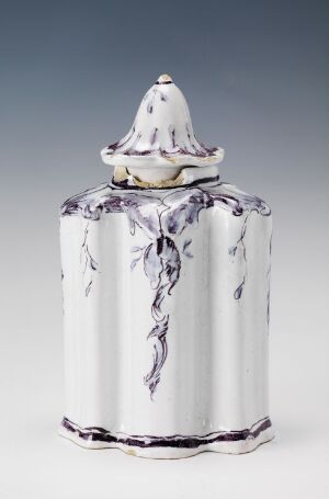 
 An unknown artist created a white-glazed faience tableware item with hand-painted manganese red vine-like decorations. The piece has a cylindrical shape with a decorative lid, featuring a conical top highlighted with similar purple-toned patterns.