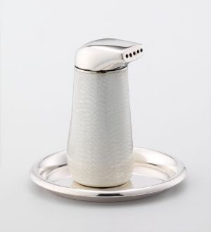  Arne Korsmo's "Pingvin" is a modern sterling silver salt shaker with white guilloché enamel on a simple, polished tray, displaying a sophisticated design that combines functionality with artistic elegance.