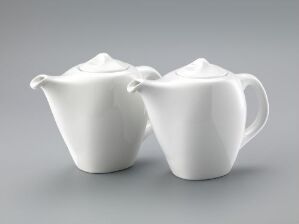  Two white vitreous porcelain teapots with a minimalist design, sitting on a gray background. The larger pot has an elegantly curved handle and spout with a rounded lid, while the smaller one mirrors the design on a smaller scale. Both display a glossy finish reflective of the støpt og glasert vitroporselen technique by artist Tias Eckhoff.