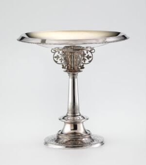  A decorative silver object, possibly a standing dish or compote, with a flat circular top, intricately decorated stem, and stable base, reflecting the craft of artist Torolf Prytz.