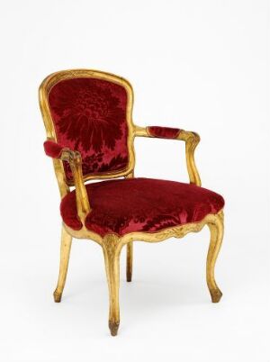 
 "Salongmøblement," an opulent gilded birch armchair with intricately carved decorations and crimson red velvet upholstery, designed by Johan J. Katzenberg.