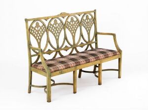 
 "Sofa" by T. H. Lunde, a wooden two-seater with beech, pine, and plywood construction, featuring a stained amber finish, a geometric lattice backrest, and a plaid-upholstered seat in dark and light browns with cream accents.