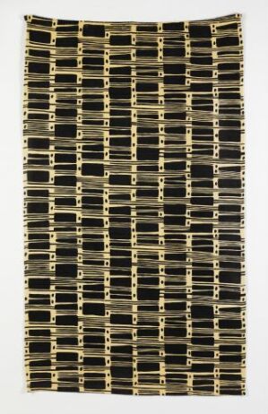  "Polynesia" by Sandvika Veveri, a machine-woven and printed cotton textile with a repeating black and beige geometric pattern resembling interconnected chains, set against a grid-like background.