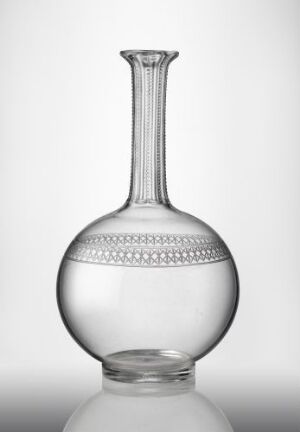  An elegant "Lucie" crystal decanter designed by Ragnvald Hansen, showcasing a clear, bulbous body with a decorative band of engraved circles, a tapered neck, and a flared lip, presented against a plain background.