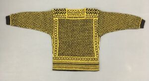  A hand-knitted woolen sweater by Den Norske Husflidsforening titled "Per Spook-genseren," featuring golden yellow and black colors, with traditional Norwegian geometric designs on the yoke, cuffs, and hem.