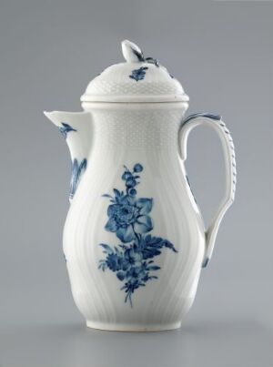  A classic white ceramic teapot with intricate blue floral designs, featuring a dome-shaped lid and curved handle, set against a soft gray background.