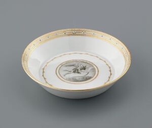  An elegant porcelain bowl with a creamy white base color, adorned with a golden rim and circular gold motifs, featuring a small gray illustration at the center.