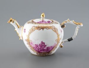  An ornate, white porcelain teapot with pinkish-purple painted scenes and gold accents, featuring a curvy handle and a long spout, displayed against a light grey background.