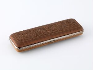  An elongated, wooden case with intricate floral patterns and a metallic trim on a white background.