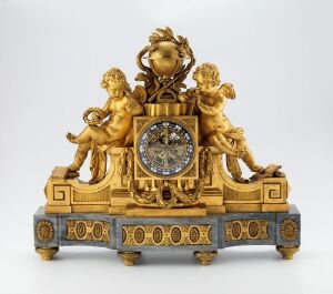  An elaborate golden clock with a central timepiece surrounded by sparkling stones and flanked by two playful cherubic figures, with cobalt blue accents on the base against a plain grey background. Artist name and title are unknown.