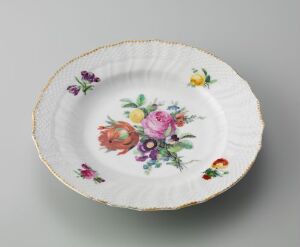  An oval porcelain plate with scalloped edges and a gold rim, featuring a painted floral design with a large pink rose in the center surrounded by smaller flowers in shades of purple, orange, and yellow on a white background. Artist name and title are unknown.