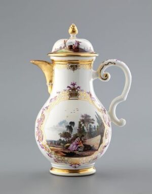  An ornate porcelain coffee pot with a painted pastoral scene featuring a couple in vintage clothing, set against a countryside background, with elegant gold trimming along the spout, handle, neck, and base. The pot is predominantly white and is set against a neutral grey backdrop.