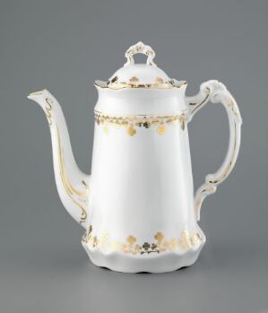  An elegant white feldspar porcelain coffee pot with gold trim and stamped floral decorations. The artist is unknown.