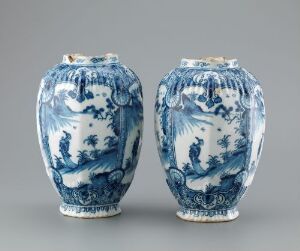  A pair of blue and white porcelain vases with detailed cobalt blue patterns on a white background. The vases have an oval shape with flared rims, embellished with traditional designs and scenes.