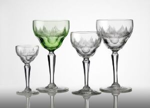  A collection of four blown glass goblets with faceted, olive, and sheared cut decorations, ranging in size and including one with a green tinted bowl, crafted by Hadeland Glassverk.