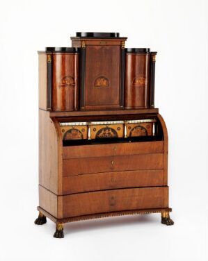  An antique wooden cabinet with a polished finish featuring three cylindrical containers on top, ornate carving in the middle section, and a variety of drawers with golden handles, standing on paw-shaped feet.