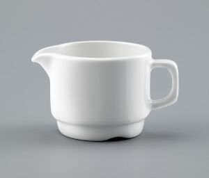  A white vitreous porcelain creamer with a glossy glaze, designed by Ragnar Grimsrud, stands on a grey backdrop, featuring a rounded spout and handle with a minimalist design.