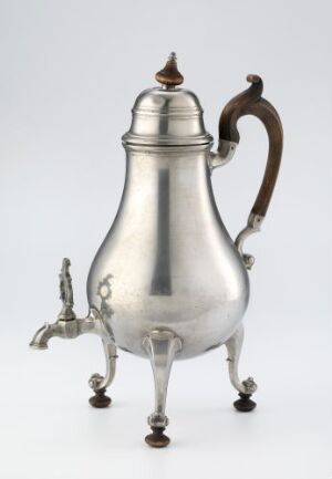  An antique "Temaskin" teapot made of cast and soldered tin with a wooden handle and finial, displaying a traditional metallic sheen with three decorative feet and a smoothly curved body. The artist is unidentified.