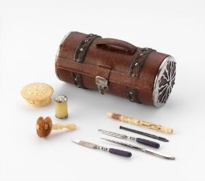  An antique-style sewing kit with a cylindrical leather case, a pin cushion, and various tools with blue and brown handles on a light gray background.