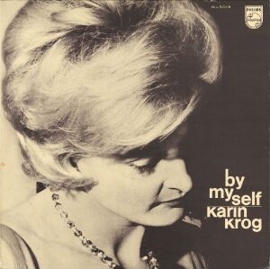  Album cover for "By Myself" by Karin Krog, designed by Chris White, featuring a monochromatic close-up portrait of Karin Krog looking introspective, with a short 1960s hairstyle and wearing a beaded necklace. The text is minimal and placed in the bottom right corner against a grayscale background.