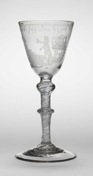  An intricately engraved clear glass goblet by Nøstetangen glassverk, featuring a detailed pastoral scene on the bowl, a spiral twisted stem, and a circular foot. The artwork is monochromatic, with shades of grey highlighting the texture and craftsmanship of the blown glass with engraved decor.