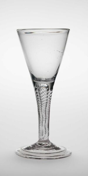  A clear glass with a slender, twisted stem design, titled "Nøgen Jomfru," against a neutral background, embodying an elegant and artistic piece of tableware.