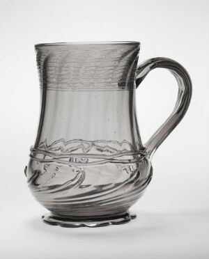  A clear glass pitcher with decorative horizontal bands and a curvy handle, displayed against a light gray background.