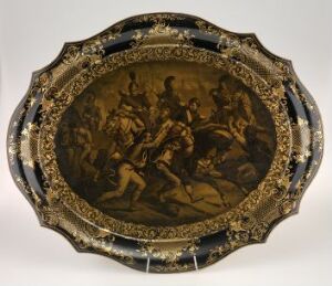  An oval-shaped platter with a scalloped edge featuring a central brown monochromatic image depicting a scene with multiple figures surrounded by a golden ornate border with possible floral and foliage motifs on a contrasting dark background.