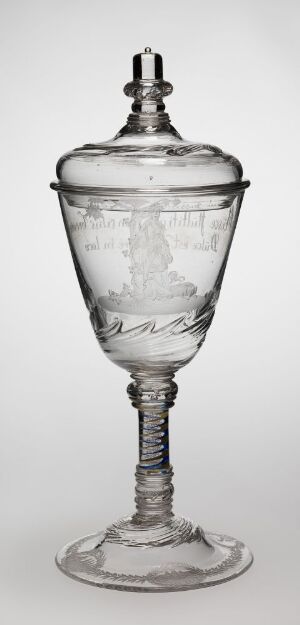  An elegant, transparent stemmed glass with a lid featuring spiral design on the stem and intricate etching on the body, set against a light gray background.