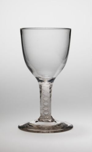  A clear glass wine goblet with a twisted stem stands against a neutral background, its reflective surface and elegant form highlighted by soft lighting.