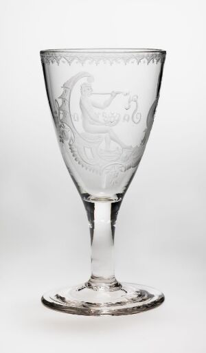  A tall, clear engraved glass goblet with a sophisticated design, featuring a flat circular base, a sleek stem, and a bowl with an intricate crest or emblem etched onto it, set against a white background.