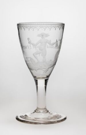  A clear etched glass goblet with a decorative stem and broad base, featuring intricate designs and scenes etched into the bowl, set against a light background.