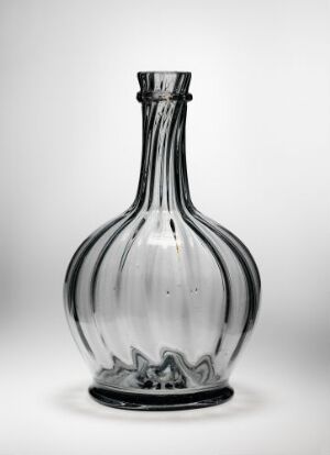  A clear glass vase with vertical ridges on a light grey background, featuring a bulbous body and a short flared neck, displaying subtle smoky coloration.