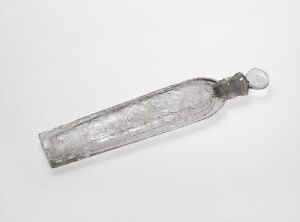  A vintage transparent glass bottle with an octagonal body and decorative pattern, featuring a small round stopper connected by a glass neck, displayed against a light grey background. Artist name and title unknown.