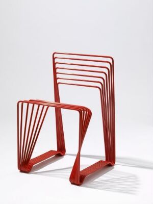  "Red Chair" by Alexander Lervik, a minimalist furniture design made from form-bent, lacquered red steel tubes arranged in parallel to form the seat and backrest, with the background in a light neutral tone.