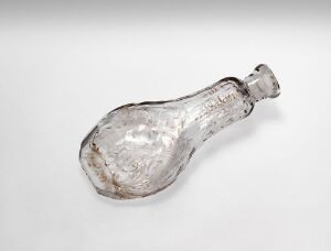  A clear antique glass bottle with a bulbous base and a narrow neck, set against a light grey background, exhibiting textured imperfections indicative of hand-blown craftsmanship. The bottle appears slightly blue-tinted and its stopper is missing, enhancing its historic charm. Artist name and title remain unknown.