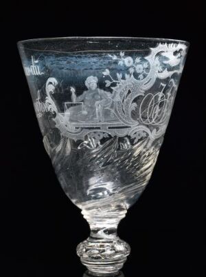  An intricately engraved clear glass goblet with historical or mythological scenes against a dark background, showcasing shades of grey from light reflections and shadows. Artist name and title are unknown.