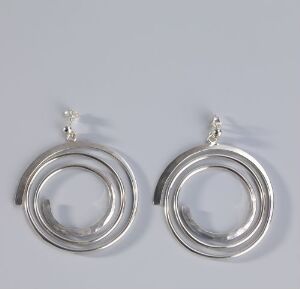  A pair of hand-forged sterling silver earrings by Anna-Greta Eker featuring three concentric circles with a polished finish on a soft grey background.