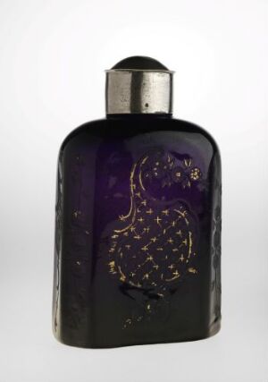 Alt-Text: A deep purple glass perfume bottle with gold speckled details on a light background, exhibiting a luxurious and simple design. Artist name and title are unknown.