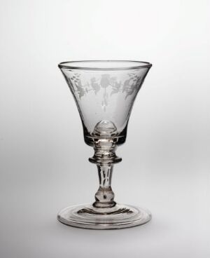  A clear glass goblet with a flared bowl, a spherical knob on the stem, and a broad circular base on a light background.