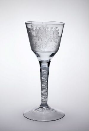  A clear, engraved glass goblet by Hurdal glassverk with a twisted stem and delicate floral engravings on the bowl, showcased against a light gray background.