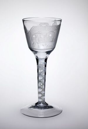  An engraved glass goblet created by Hurdal glassverk, with intricate floral patterns on the cup and a twisted stem design, displayed on a white background.