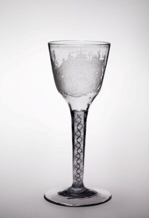  An engraved glass goblet by Heinrich Gottlieb Köhler against a white background, featuring a transparent bowl and stem with a frosted, engraved band in the middle and a twisted design on the stem.