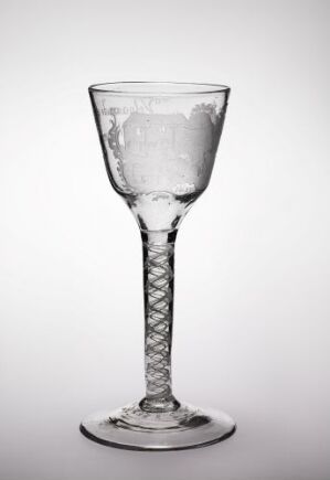  An elegant clear glass wine glass with a twisted stem pattern, placed against a light grey background.