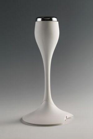  A modern white light fixture designed by Carl Öjerstam, with a smooth, tapered design resembling a slender vase and a polished metal cap, standing against a gradient grey background.