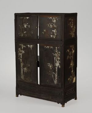  An antique dark wooden cabinet with upper and lower sections, featuring light-colored floral inlays or paintings on the doors, against a soft gray background.