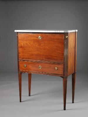  A polished wooden chest of drawers with a reddish-brown hue and brass circular handles on two large drawers, standing on four tapered legs. The top surface is framed with a lighter-toned edge.