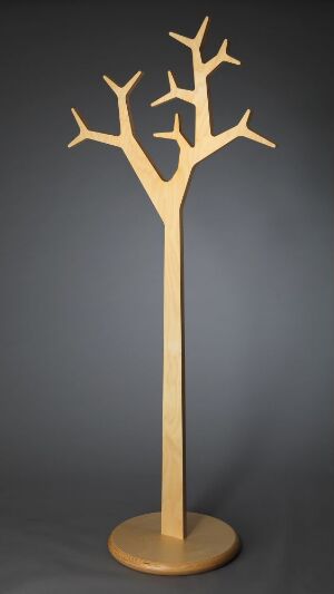 
 A modern coat stand designed by Katrin Ólina Pétursdóttir, made of laminated birch wood with a lacquered surface, featuring a slender pole and symmetrical branches serving as hooks against a dark background.